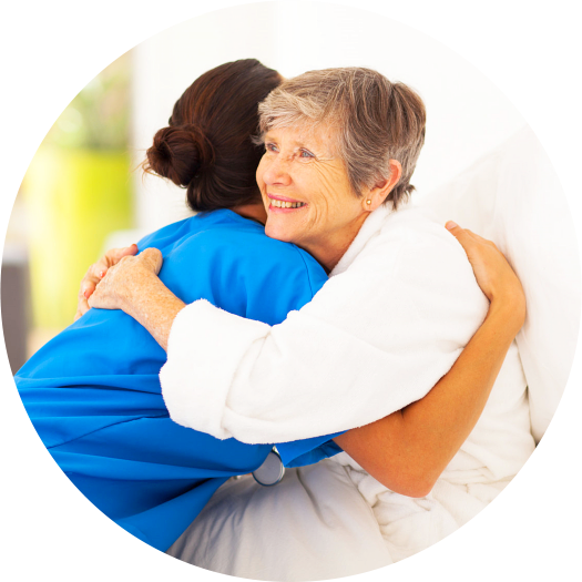 nurse and elderly woman hugging each other